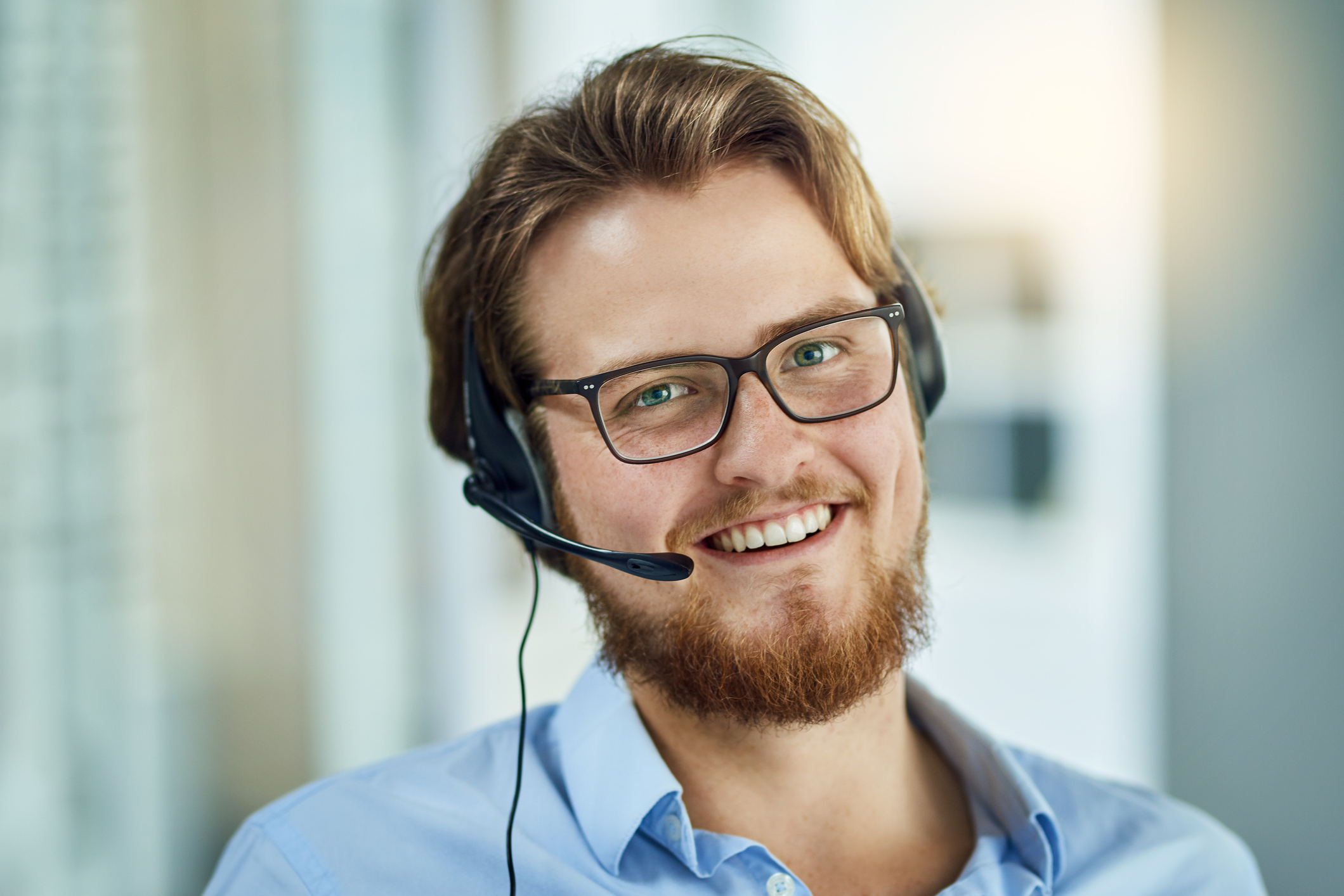 Portrait of a young call centre agent working in an office