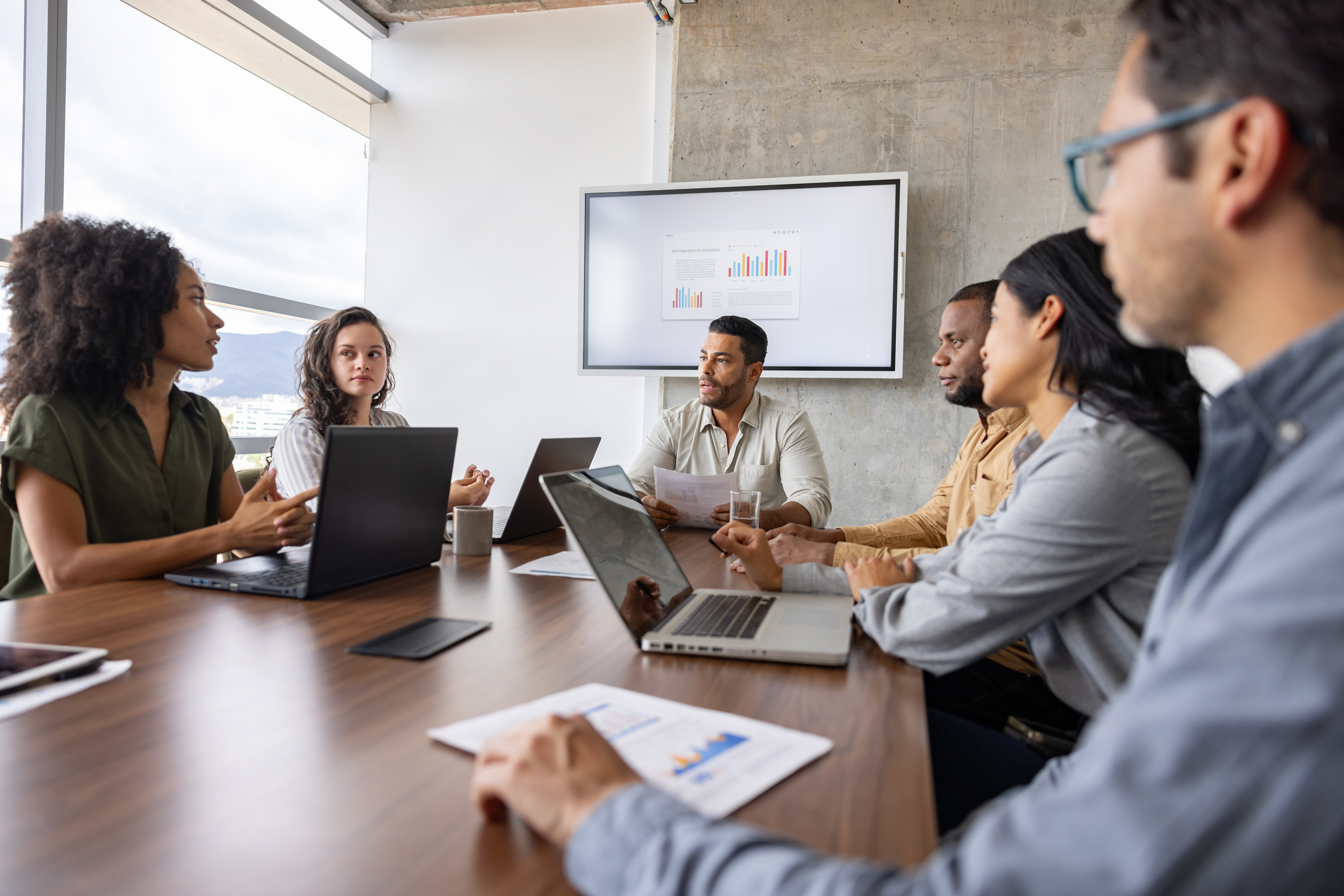 Group of Latin American business people having a discussion in a meeting at the office - teamwork concepts